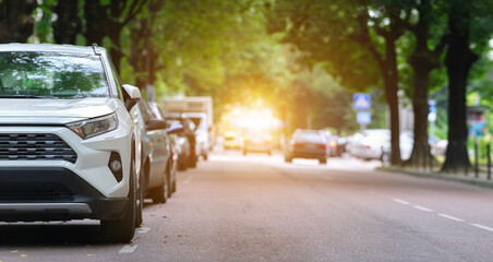 City traffic with cars parked in line on street side. Vehicle parking concept.