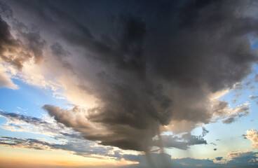 Landscape of dark clouds forming on stormy sky during thunderstorm.