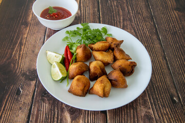 Vegetarian Samosa with potato filling on wooden table
