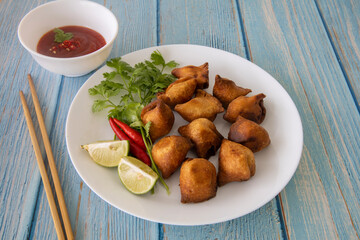 Vegetarian Samosa with potato filling on wooden table