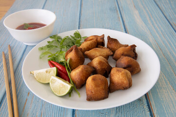 Vegetarian Samosa with potato filling on wooden table