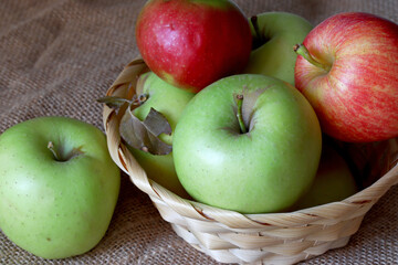 green and red apples in a wicker basket