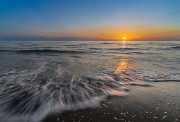 the sea and the beach at sunset © adrian