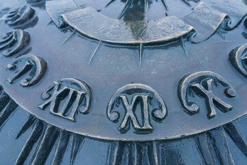 Details of big decorative street clock. Concept of the time. Roman numerals. Close up photography