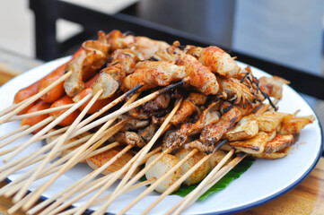 barbecued pork or spicy barbecued or spicy satay ,sausage and meatball