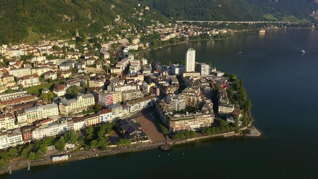 Aerial drone footage of the famous Montreux lakefront area by lake Geneva in Canton Vaud in Switzerland. Shot with a rotation and tilt down motion. 