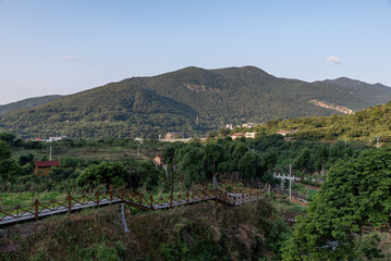 Naklejka premium The rural scenery after the rain, houses, green mountains and rivers