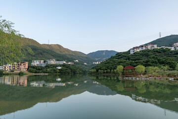 The lake reflects the mountains and villages