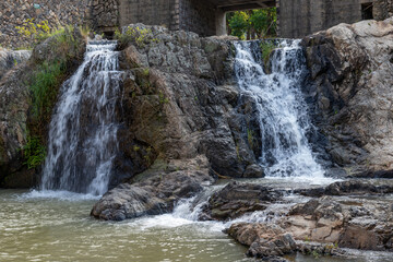 The water in the river forms a small waterfall