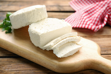 Delicious fresh cottage cheese on wooden table, closeup