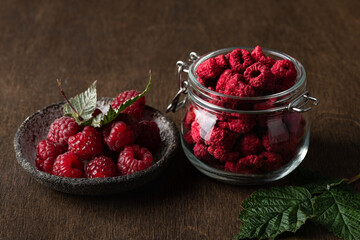 freeze-dried raspberries in a glass jar on wooden background
