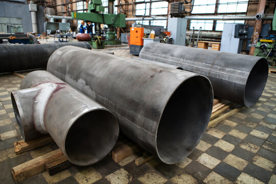 Metal pipes for the assembly of technical pipelines. Preparation of alloy parts for installation on an industrial line. Foreground. Selective focus
