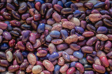 Colored beans on a wooden background