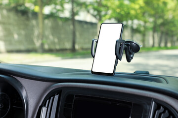 Car holder with modern mobile phone on windshield of automobile. Mockup for design