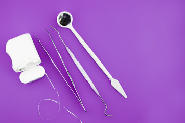 Dental instrument set, basic dental instruments isolated on purple background, side view