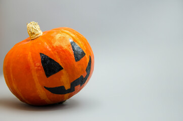 Halloween card. Jack. orange pumpkin painted with black paint for a holiday, one scary pumpkin among the normal