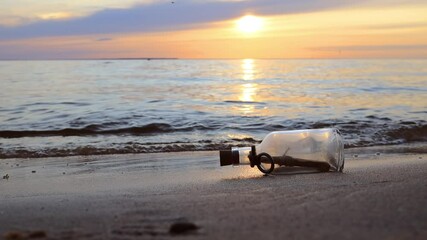 Message in the bottle against the Sun setting down