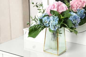 Beautiful hortensia flowers in vase on dressing table indoors. Space for text