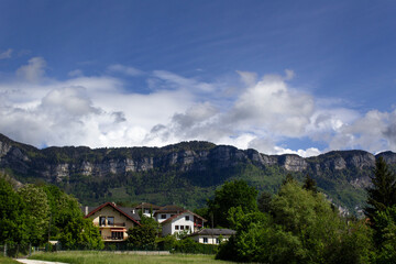 Fototapeta na wymiar mountain revard green summer view with houses and blue sky savoie region france 