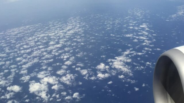 Looking through window aircraft during flight next to the wing with sky