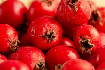 Beautiful photos of red hawthorn berries on a wooden table. Close-up.