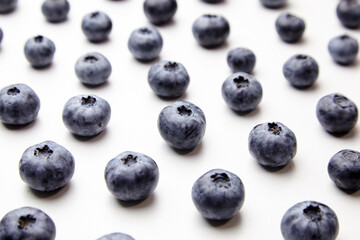 Blueberries with shadows on white table