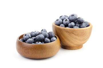 Blueberry in wooden bowl isolated on white background