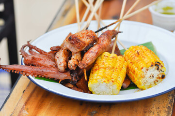grilled squid, grilled pork and grilled corn