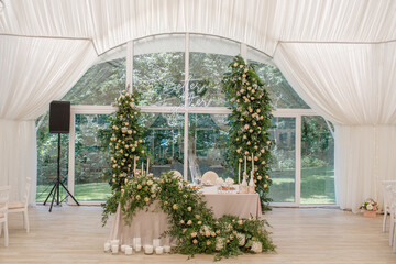 Wedding Setup . Wedding decor. Banquet. The chairs and round table for guests, served with cutlery, flowers and crockery