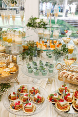 Wedding. Candy bar. Candy bar at banquet. Wedding table with sweets, cake, pastries, muffins, sugar treats. Event in restaurant
