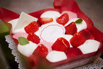 Strawberry cake with whipped cream on the table