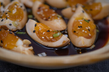 Soy pickled eggs, sliced, with chopsticks