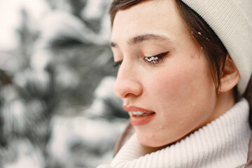 Outdoor photo of cozy female in winter forest