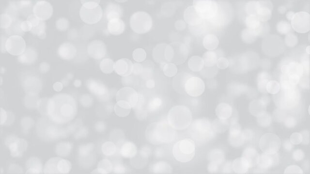 Abstract bokeh background animation with gently flickering defocused white bokeh spheres moving left to right. This simple monochrome motion background is full HD and a seamless loop.
