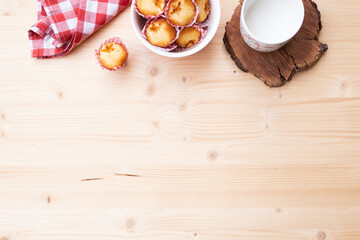 Breakfast top view of muffins and a cup of milk, accompanied by a red cloth with copy space