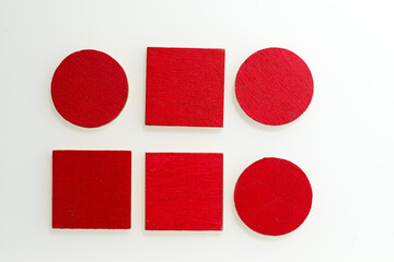 wooden shapes painted red on white