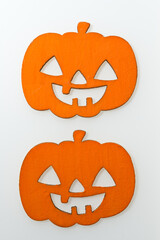 two halloween jack o lanterns on an illuminated white background