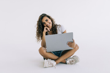 Happy smiling woman working on laptop isolated on white background