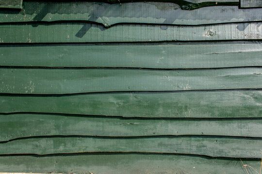 Green wooden shed wall from planks