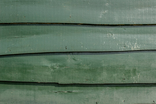 Green wooden shed wall from planks