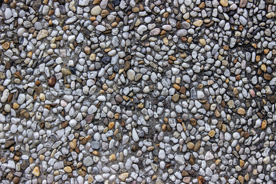 Wall made of little stones close up (gravel wall)
