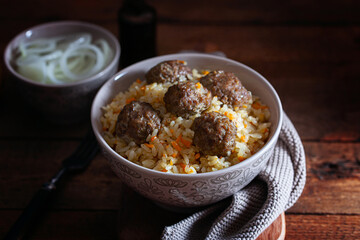 Uzbek pilaf with white rice and beef meatballs, horizontal