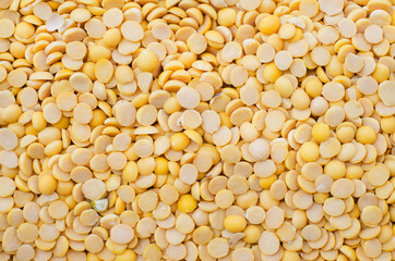 Dry organic split yellow mung bean background, read for clean food ingredient cooking or agricultural product concept