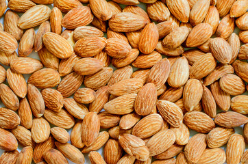 Group of dry organic almond seed pile background for dessert ingredient or protein food and agricultural product concept