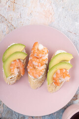 Breakfast with sandwiches, shrimp sandwiches and avocado top view