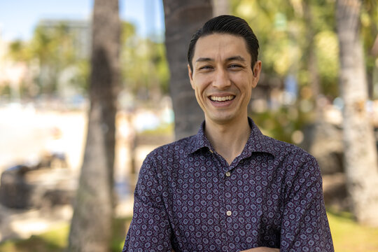Asian man at Waikiki beach in Hawaii portrait smile happy face
