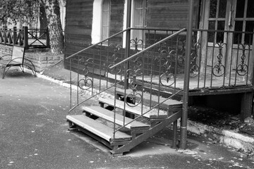 Stairs to a wooden house, black and white image