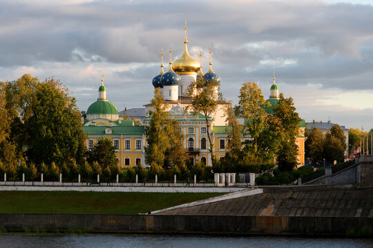 Beautiful city Tver landscape view of imperial palace on river Volga embankment with garden trees, dramatic autumn evening sky and russian buildings. Small city architecture concept. Tver, Russia.