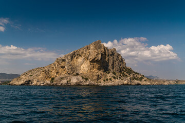Fototapeta na wymiar The Republic of Crimea. July 21, 2021. View of Mount Alchak near the city of Sudak from the Black Sea.
