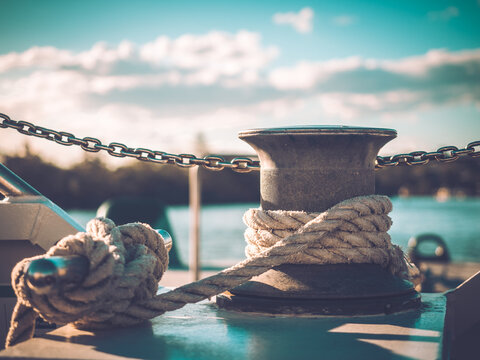 Rope knotted around steel pole for securing the boat
